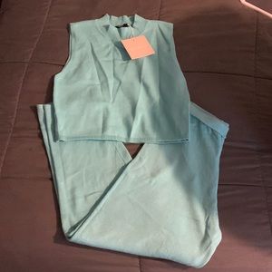 Kittenish turquoise two piece outfit.